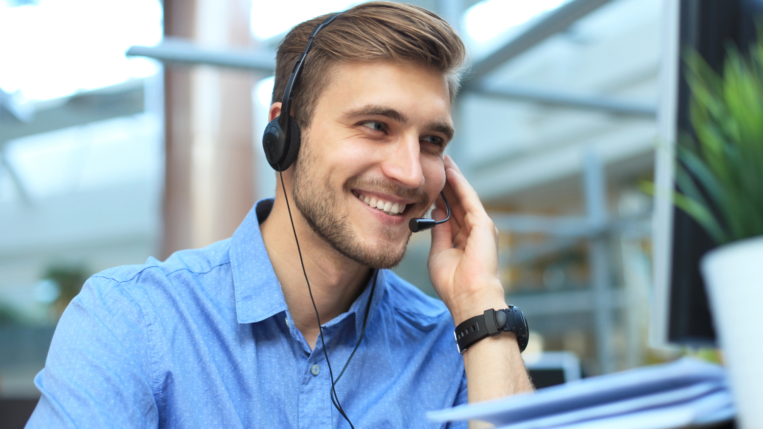 Call centre worker utilising a VoIP business phone system from home.