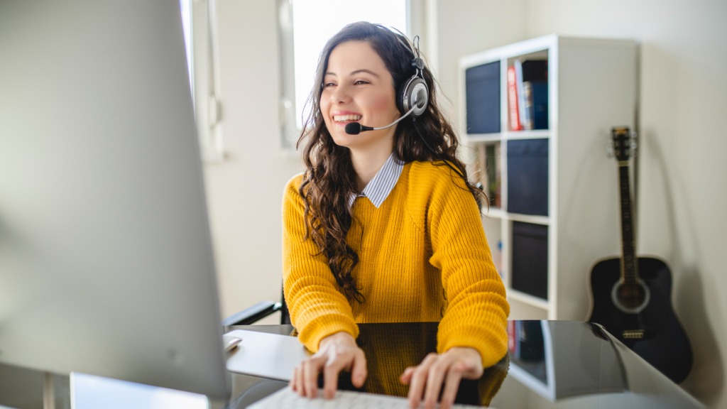 Young woman having video call on computer at home