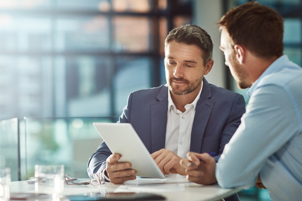 Two men involved in a meeting about IT communications