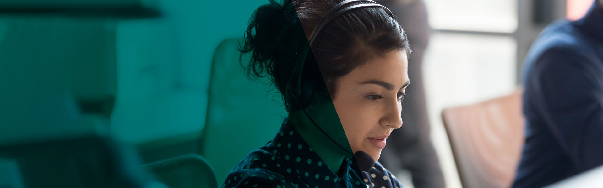 A contact centre agent wearing a headset focused on a customer call, representing Elite Group's business communication and call management solutions